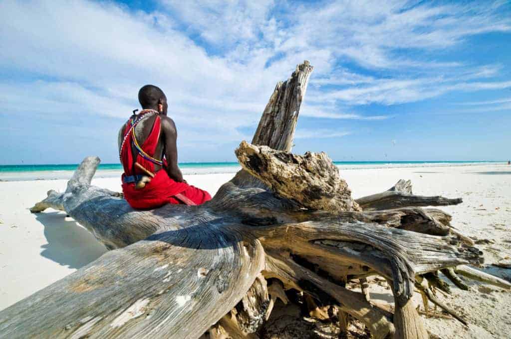 Maasai sitting by the ocean on the beach